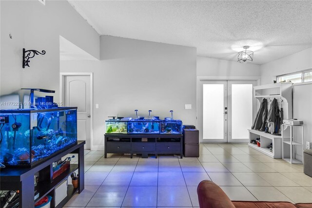 12332 NW 97th Ct, Hialeah Gardens, FL 33018 - playroom featuring french doors, lofted ceiling, tile patterned floors, and a textured ceiling