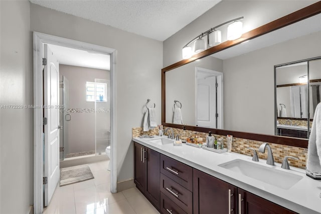 12332 NW 97th Ct, Hialeah Gardens, FL 33018 - bathroom featuring a stall shower, tasteful backsplash, toilet, double vanity, and tile patterned flooring