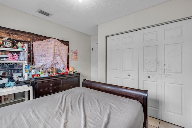 12332 NW 97th Ct, Hialeah Gardens, FL 33018 - tiled bedroom with a textured ceiling and a closet