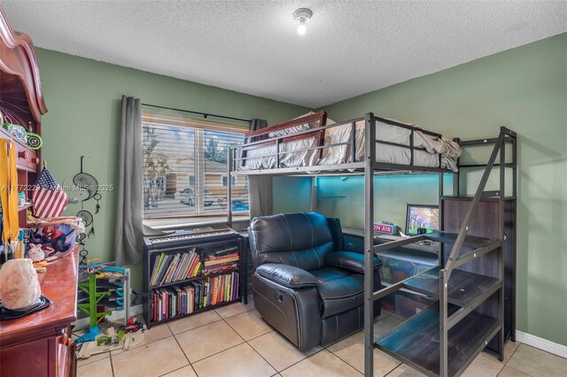 12332 NW 97th Ct, Hialeah Gardens, FL 33018 - bedroom with a textured ceiling, light tile patterned floors, baseboards, and connected bathroom