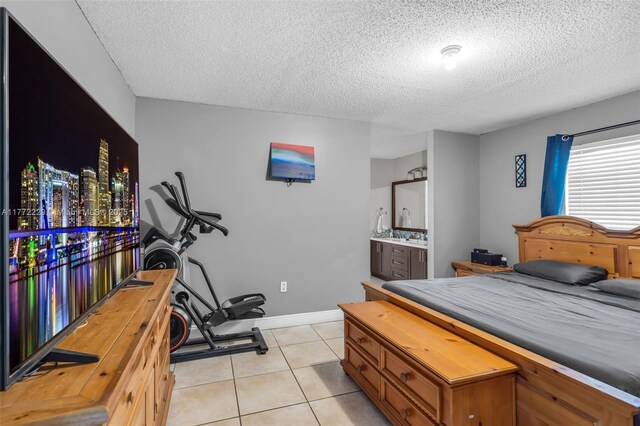12332 NW 97th Ct, Hialeah Gardens, FL 33018 - bedroom featuring a textured ceiling, light tile patterned floors, baseboards, and ensuite bathroom