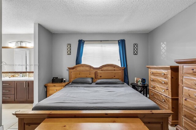 12332 NW 97th Ct, Hialeah Gardens, FL 33018 - bedroom with a textured ceiling, ensuite bathroom, and light tile patterned floors