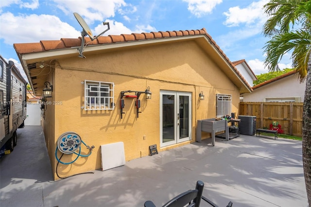 12332 NW 97th Ct, Hialeah Gardens, FL 33018 - back of property with fence, stucco siding, a patio, and central AC unit