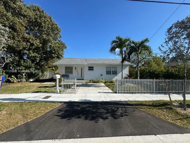 3005 SW 24th Ter, Miami, FL 33145 - view of front of home featuring a fenced front yard, driveway, and stucco siding