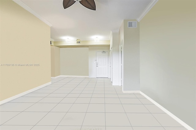 spare room with crown molding, a ceiling fan, baseboards, and light tile patterned floors