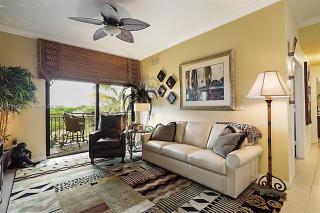 living area featuring tile patterned flooring, a ceiling fan, ornamental molding, and baseboards