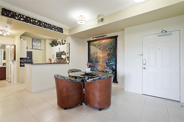 dining area featuring crown molding, light tile patterned flooring, and baseboards