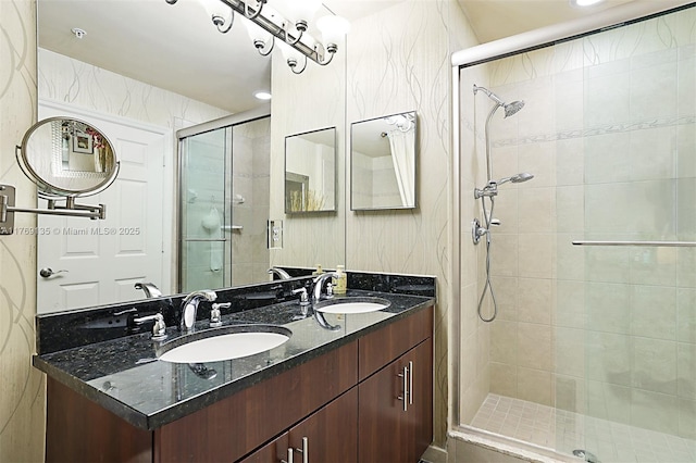 full bathroom featuring a stall shower and double vanity