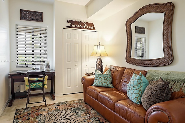 living room with baseboards and light carpet