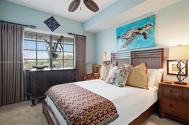 bedroom with light colored carpet and a ceiling fan