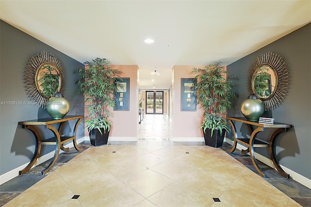 hall featuring baseboards, tile patterned flooring, and recessed lighting