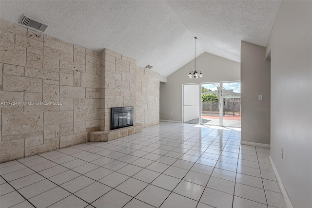 unfurnished living room featuring a textured ceiling, visible vents, a chandelier, a fireplace, and light tile patterned floors