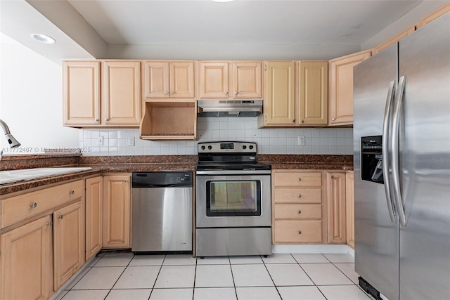 kitchen with a sink, light brown cabinetry, appliances with stainless steel finishes, under cabinet range hood, and decorative backsplash