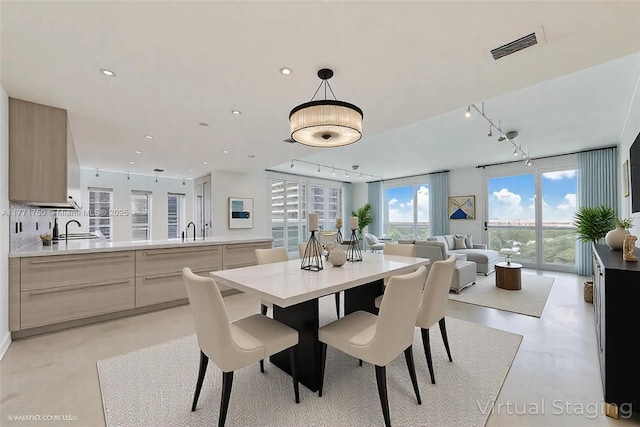 2645 S Bayshore Dr Unit 902, Miami, FL 33133 - dining space featuring rail lighting, concrete flooring, and recessed lighting