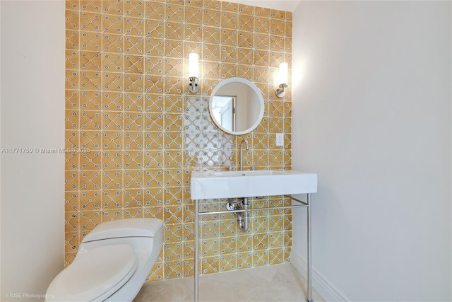 2645 S Bayshore Dr Unit 902, Miami, FL 33133 - half bathroom featuring toilet, a sink, and tile walls