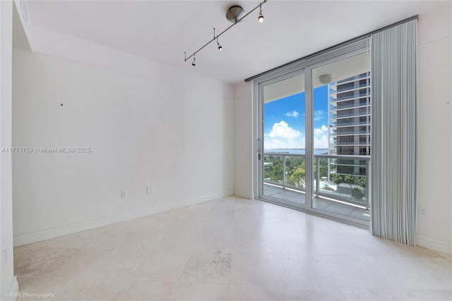 2645 S Bayshore Dr Unit 902, Miami, FL 33133 - unfurnished room featuring floor to ceiling windows and baseboards