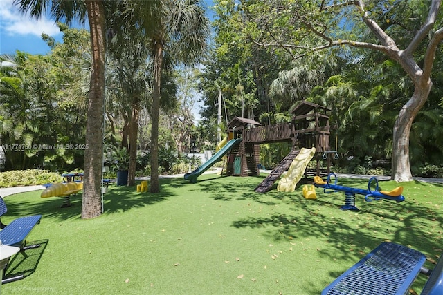 2645 S Bayshore Dr Unit 902, Miami, FL 33133 - view of playground featuring a lawn and view of wooded area