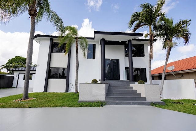view of front facade featuring a front lawn and stucco siding