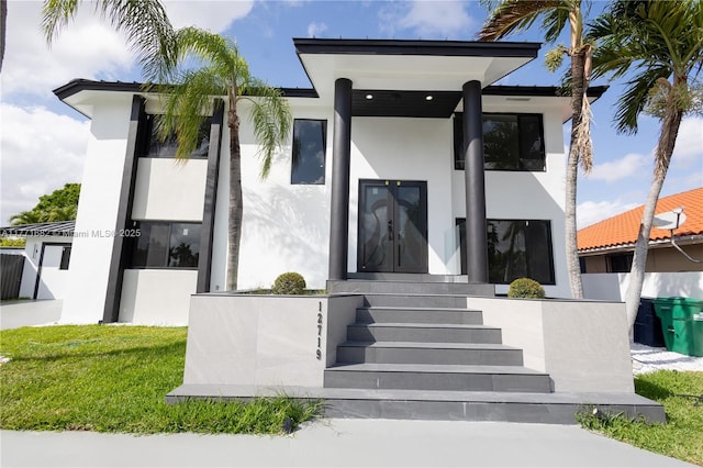 view of front of home featuring a front yard and stucco siding