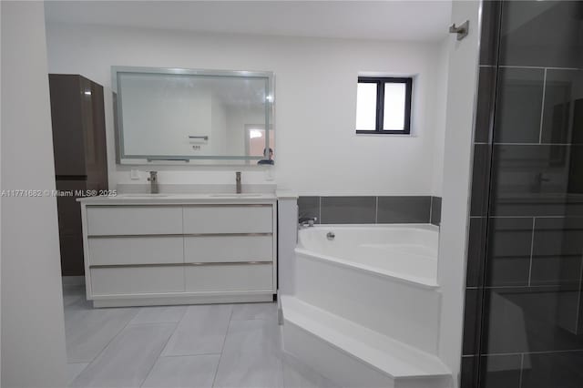 full bath featuring double vanity, a bath, and a sink