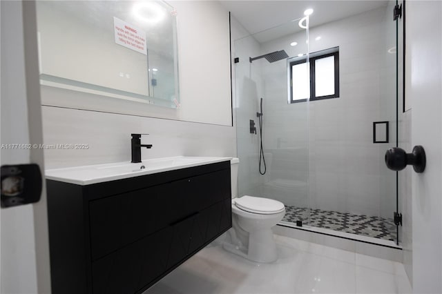 full bath featuring a shower stall, toilet, and vanity