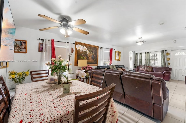 dining space with a ceiling fan and light tile patterned flooring