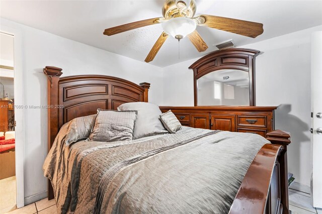 bedroom featuring a ceiling fan, light tile patterned flooring, and visible vents