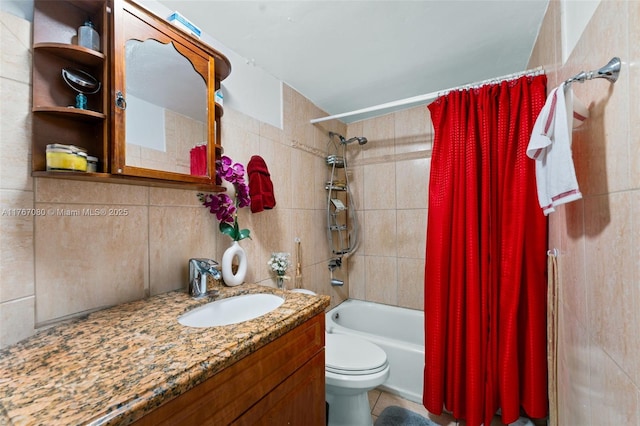 bathroom featuring tile walls, shower / bath combo with shower curtain, toilet, and vanity