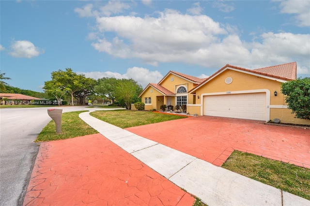1400 SW 54th Ave, Plantation, FL 33317 - view of front of home featuring driveway, stucco siding, a front lawn, an attached garage, and a tiled roof