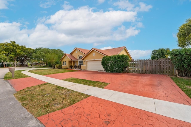 1400 SW 54th Ave, Plantation, FL 33317 - view of front of property with decorative driveway, a garage, and stucco siding
