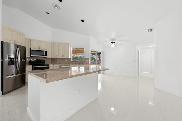 1400 SW 54th Ave, Plantation, FL 33317 - kitchen with appliances with stainless steel finishes, cream cabinets, a sink, backsplash, and light stone counters