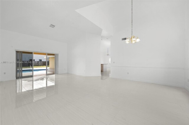 1400 SW 54th Ave, Plantation, FL 33317 - unfurnished room featuring a chandelier, light tile patterned floors, baseboards, and a high ceiling