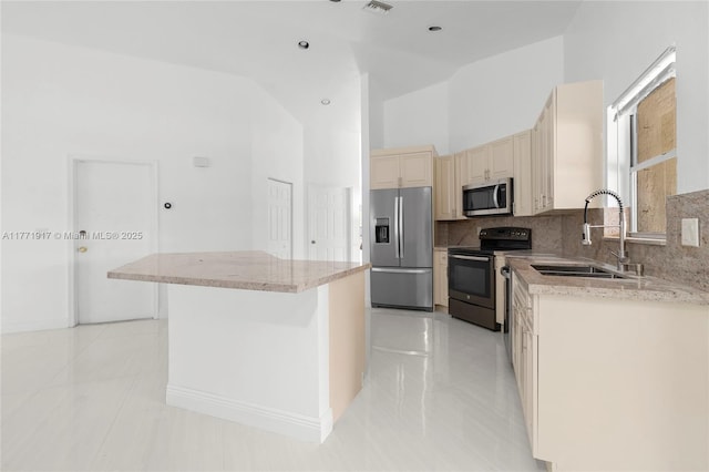 1400 SW 54th Ave, Plantation, FL 33317 - kitchen with stainless steel appliances, cream cabinetry, a sink, light tile patterned floors, and decorative backsplash