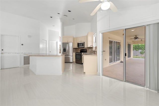 1400 SW 54th Ave, Plantation, FL 33317 - kitchen featuring stainless steel appliances, ceiling fan, light tile patterned flooring, a center island, and a high ceiling