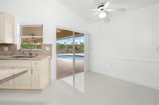 1400 SW 54th Ave, Plantation, FL 33317 - kitchen with a sink, backsplash, light stone countertops, a ceiling fan, and lofted ceiling