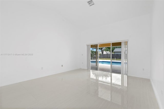1400 SW 54th Ave, Plantation, FL 33317 - empty room featuring light tile patterned flooring, high vaulted ceiling, and baseboards