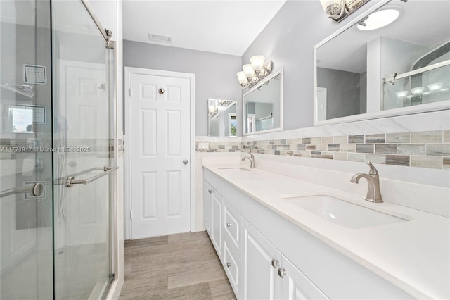 1400 SW 54th Ave, Plantation, FL 33317 - bathroom with a shower stall, double vanity, wood finished floors, and backsplash