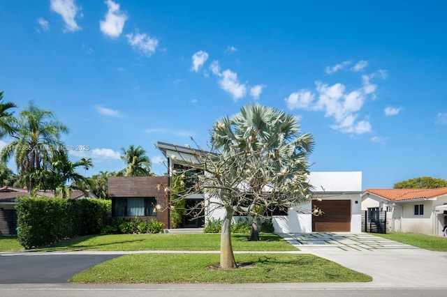 2421 NE 199th St, Miami, FL 33180 - view of front facade with stucco siding, a garage, concrete driveway, and a front yard