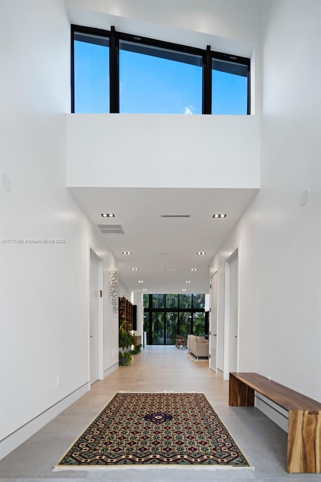 2421 NE 199th St, Miami, FL 33180 - interior space with a towering ceiling, recessed lighting, visible vents, and a wall of windows