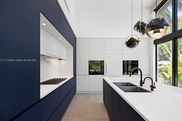 2421 NE 199th St, Miami, FL 33180 - kitchen featuring modern cabinets, light countertops, and a sink