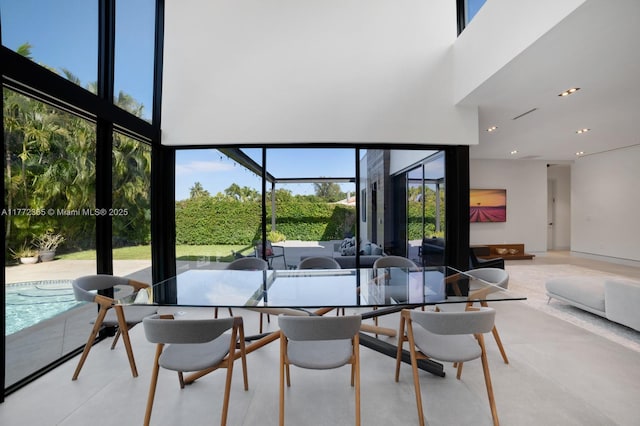 2421 NE 199th St, Miami, FL 33180 - dining area featuring a wall of windows, a high ceiling, and recessed lighting