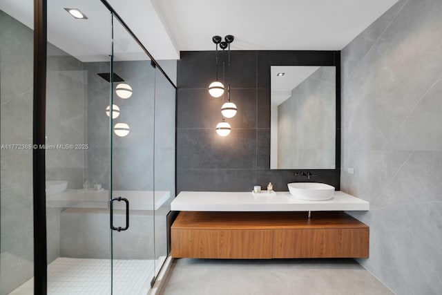 2421 NE 199th St, Miami, FL 33180 - bathroom with concrete floors, vanity, a stall shower, and tile walls