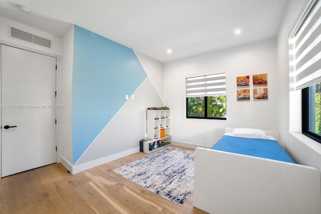 2421 NE 199th St, Miami, FL 33180 - playroom with baseboards, visible vents, a healthy amount of sunlight, and wood finished floors