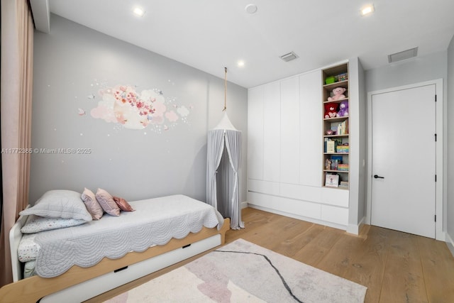 2421 NE 199th St, Miami, FL 33180 - bedroom with visible vents and light wood finished floors