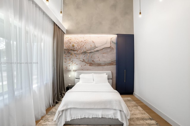 2421 NE 199th St, Miami, FL 33180 - bedroom featuring baseboards and light wood-type flooring