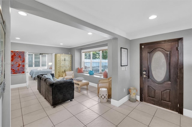 entrance foyer featuring baseboards, recessed lighting, and light tile patterned floors