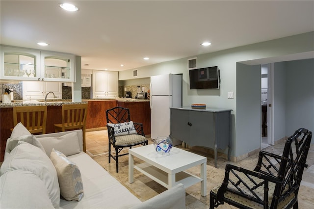 living room with recessed lighting and visible vents