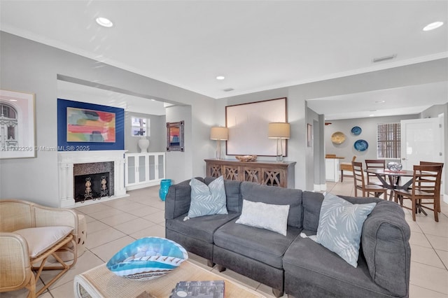 living area with visible vents, ornamental molding, recessed lighting, and light tile patterned floors