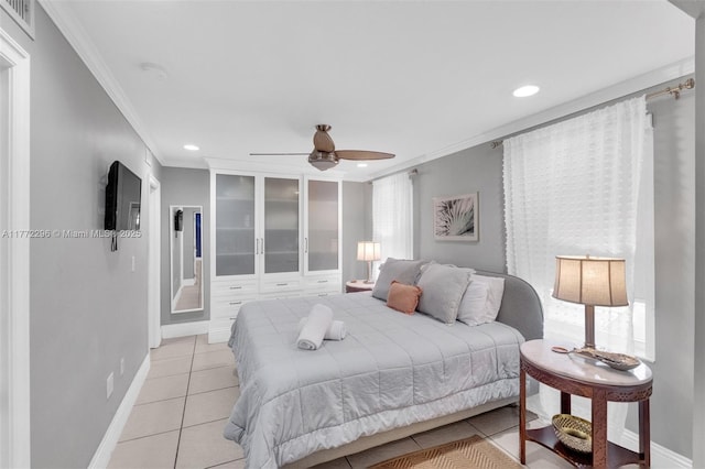 bedroom with visible vents, light tile patterned flooring, crown molding, baseboards, and ceiling fan