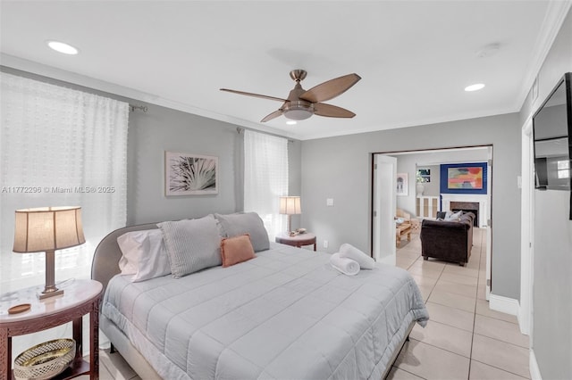 bedroom with ceiling fan, recessed lighting, crown molding, and light tile patterned floors